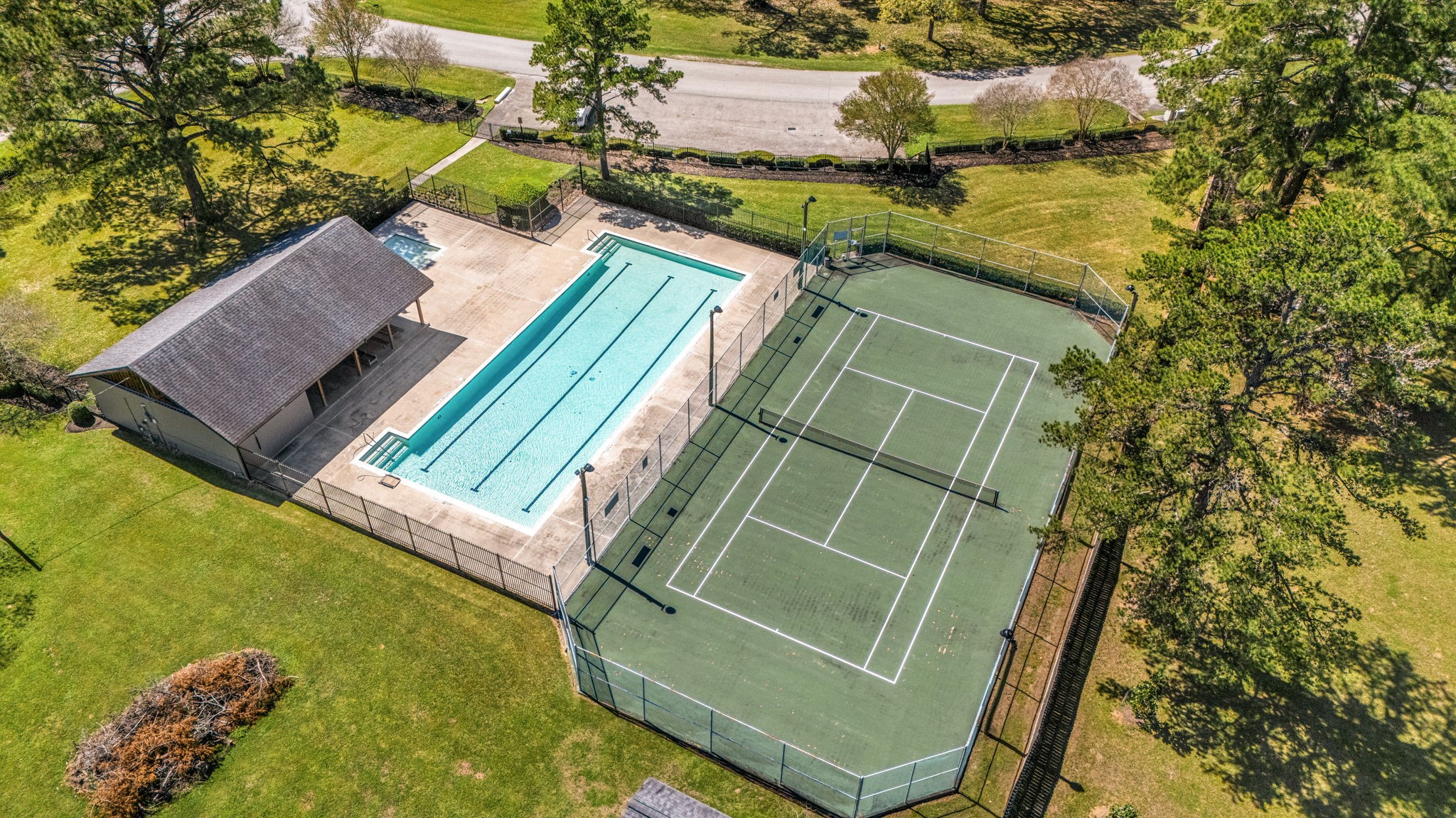 14419 Timbergreen Drive Magnolia, TX 77355 - Photo 40 of 43 Community amenities include a swimming pool and tennis courts, offering great options for recreation and outdoor enjoyment.