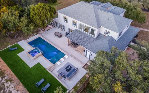 an aerial view of a house with a yard