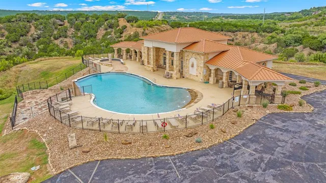 a view of a swimming pool with a yard