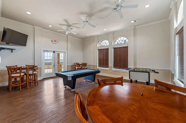 a living room with furniture a flat screen tv and kitchen view
