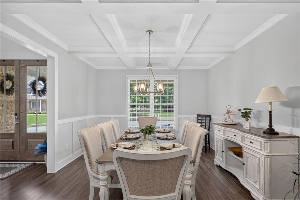 139 Manchester Lane Villa Rica, GA 30180 - Photo 7 of 60 a dining room with furniture a chandelier and wooden floor