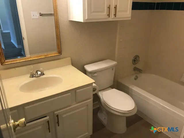 a white toilet sitting next to a bathroom sink