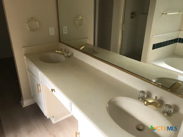 a bathroom with a tub sink and mirror