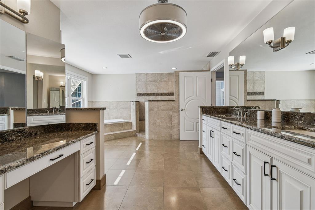 8025 Island Drive Port Richey, FL 34668 - Photo 11 of 67 a kitchen with granite countertop a sink appliances cabinets and counter space