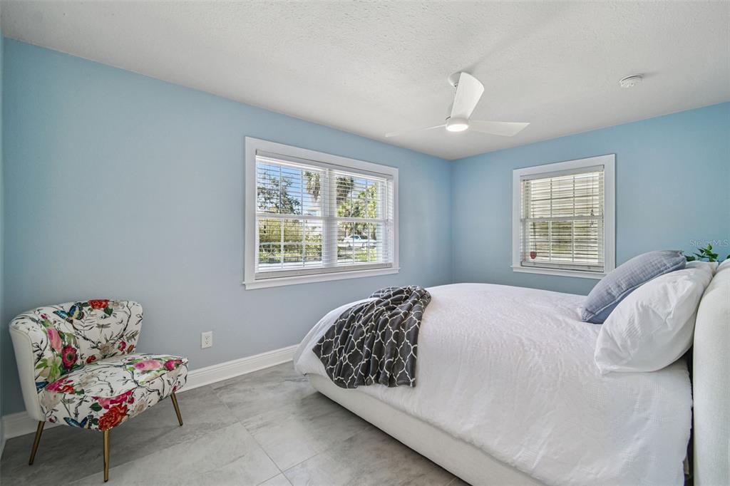 8025 Island Drive Port Richey, FL 34668 - Photo 20 of 67 a bedroom with a bed and chair