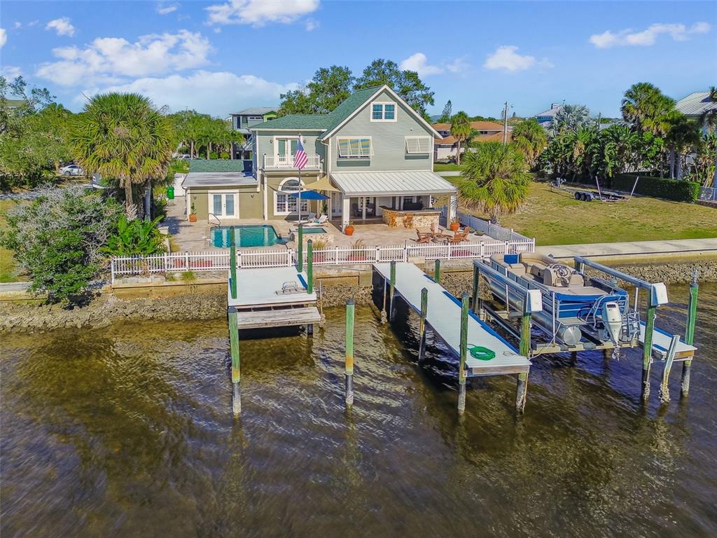 8025 Island Drive Port Richey, FL 34668 - Photo 2 of 67 a aerial view of a house with swimming pool and a yard