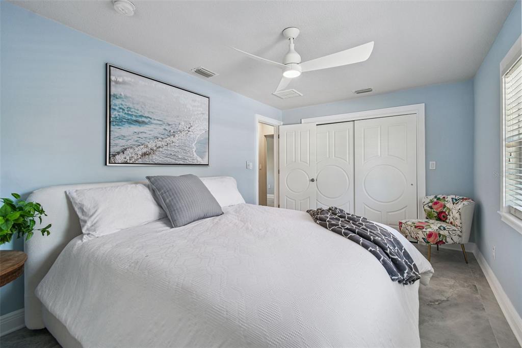 8025 Island Drive Port Richey, FL 34668 - Photo 21 of 67 a bedroom with a bed and a painting on the wall
