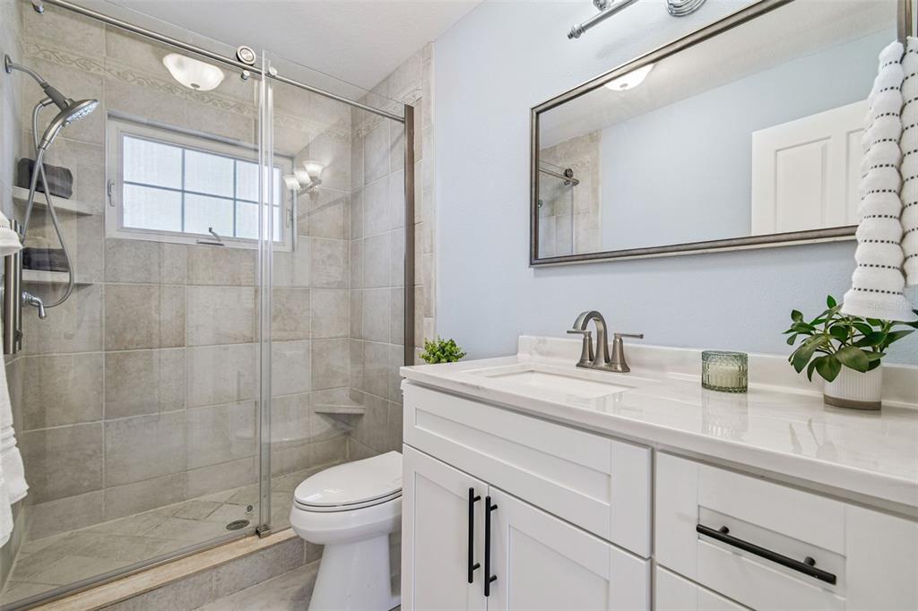 8025 Island Drive Port Richey, FL 34668 - Photo 22 of 67 a bathroom with a sink a toilet and shower