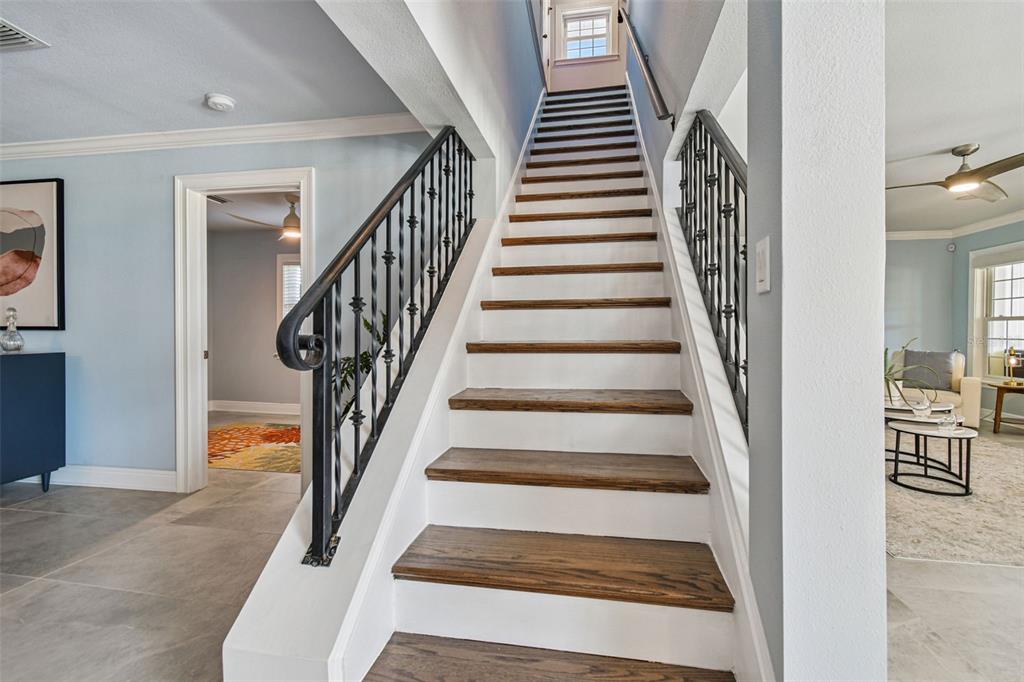 8025 Island Drive Port Richey, FL 34668 - Photo 39 of 67 a view of staircase with lots of frames on wall and a dining table