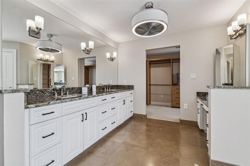 8025 Island Drive Port Richey, FL 34668 - Photo 43 of 67 a spacious bathroom with a granite countertop sink a mirror and a