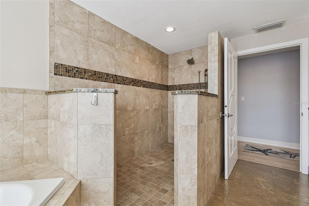 8025 Island Drive Port Richey, FL 34668 - Photo 46 of 67 a bathroom with a shower and a glass door