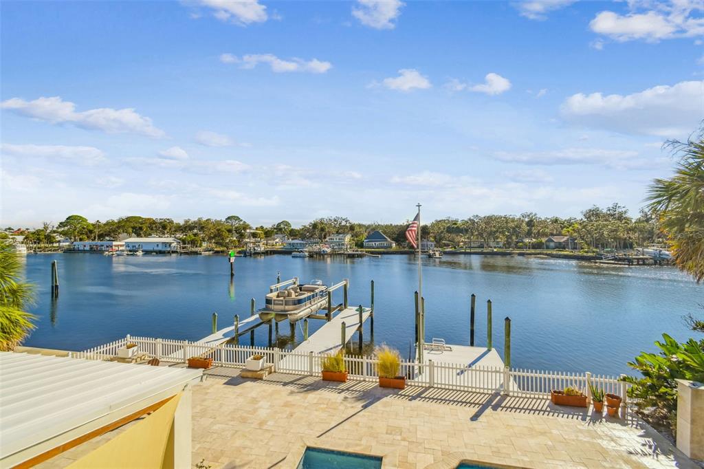 8025 Island Drive Port Richey, FL 34668 - Photo 6 of 67 a view of a lake with a table and chairs