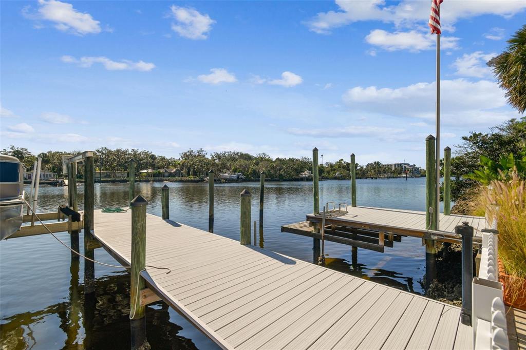 8025 Island Drive Port Richey, FL 34668 - Photo 61 of 67 a view of a lake with a table and chairs