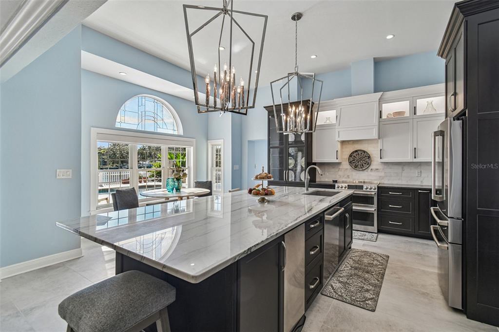 8025 Island Drive Port Richey, FL 34668 - Photo 8 of 67 a kitchen with stainless steel appliances granite countertop a sink a stove and a refrigerator