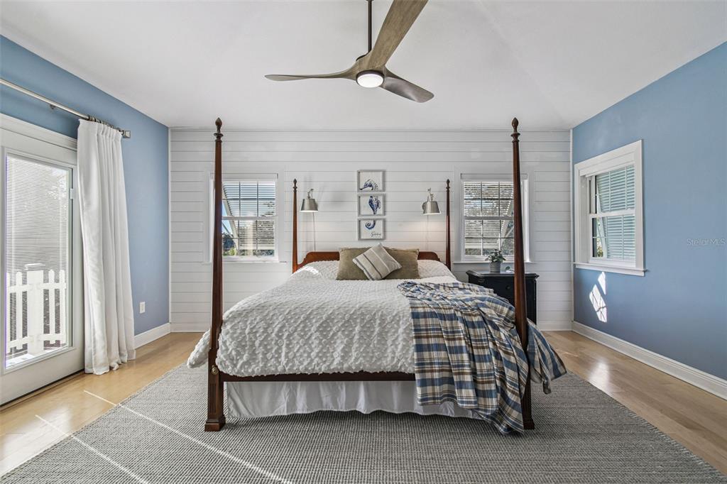 8025 Island Drive Port Richey, FL 34668 - Photo 10 of 67 a bedroom with a large bed and a chandelier