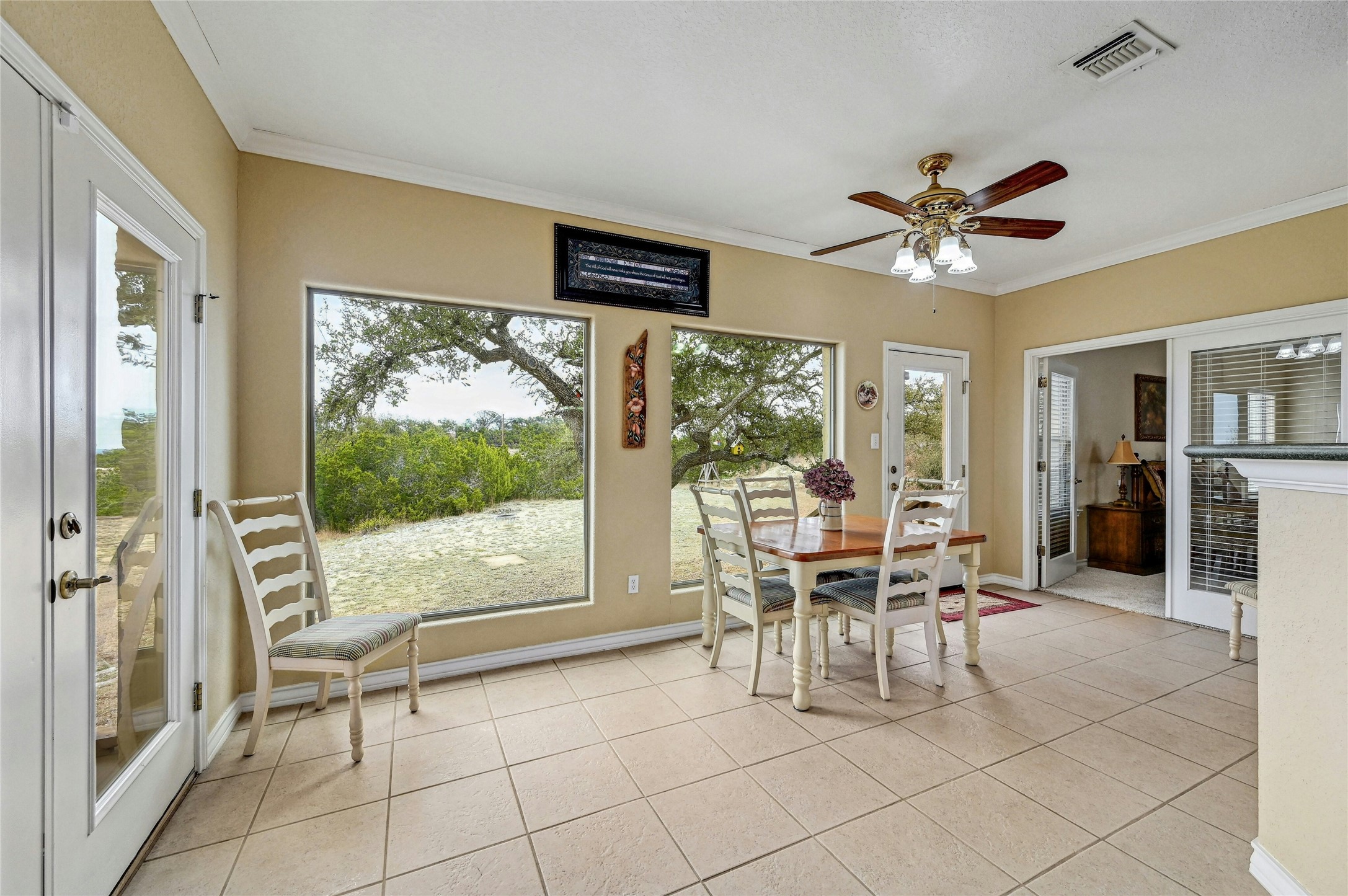 1370 Sunset View Fischer, TX 78623 - Photo 13 of 29 Light and airy, you can enjoy the outdoors without fighting the elements in this breakfast/flex room.