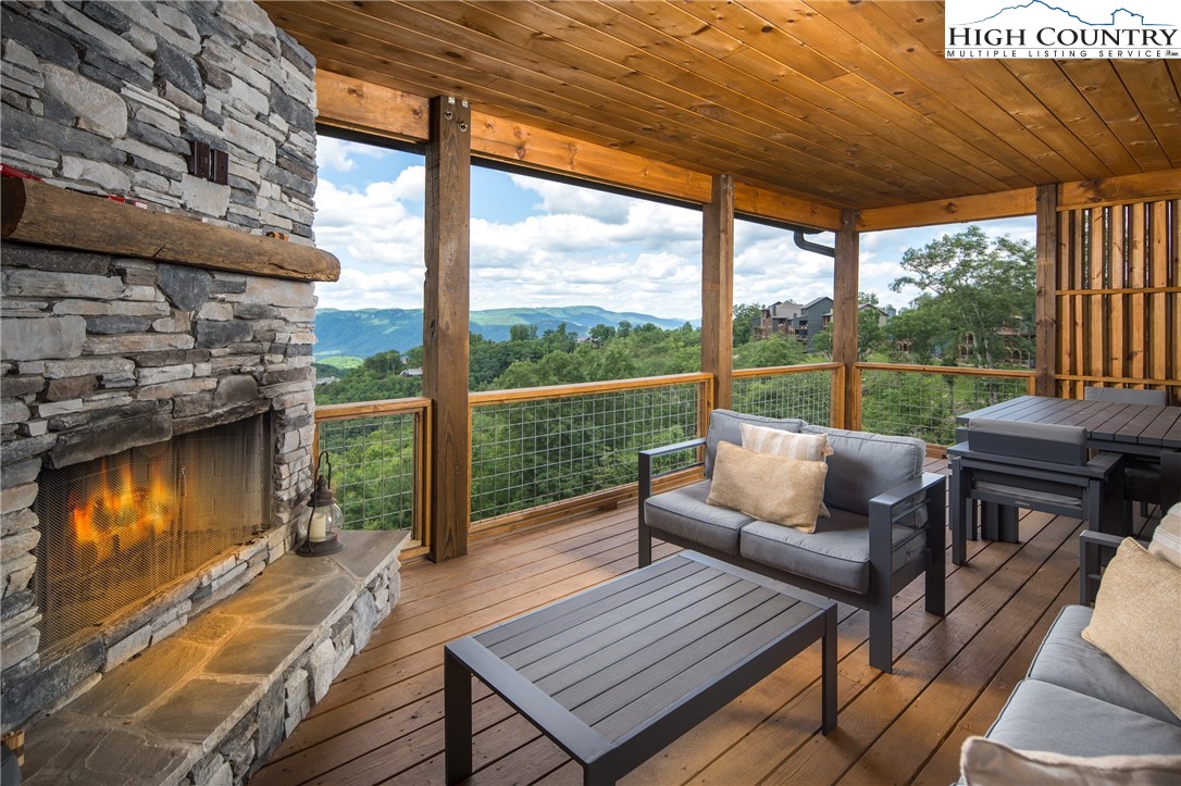 192 North Face Trail Boone, NC 28607 - Photo 12 of 38 a balcony with wooden floor table and chairs