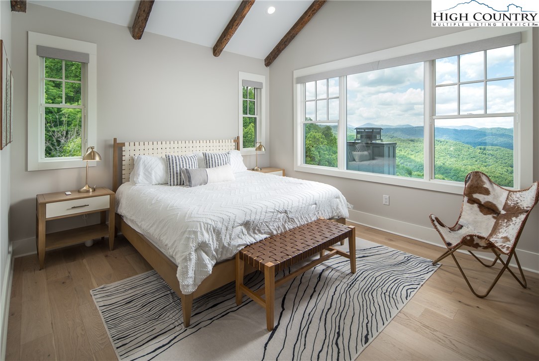 192 North Face Trail Boone, NC 28607 - Photo 15 of 38 a bedroom with a bed and large windows