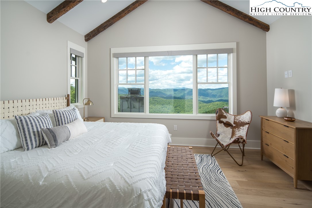192 North Face Trail Boone, NC 28607 - Photo 16 of 38 a bedroom with a bed and large windows
