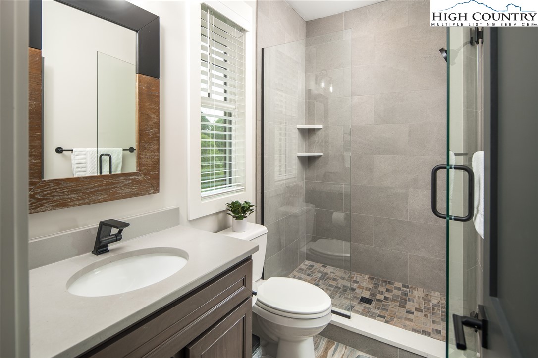 192 North Face Trail Boone, NC 28607 - Photo 23 of 38 a bathroom with a sink toilet a mirror and shower