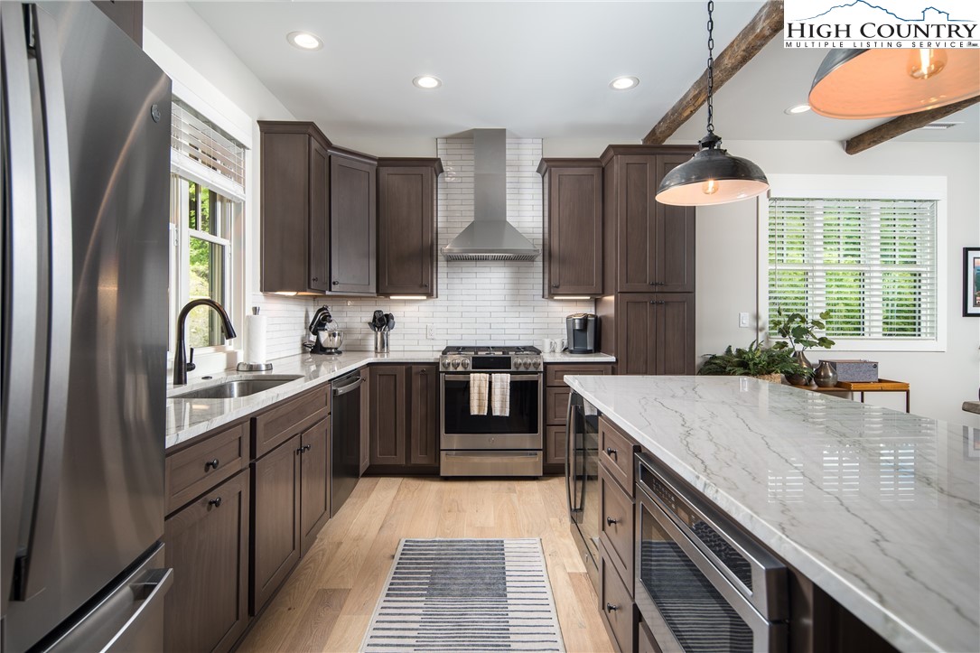 192 North Face Trail Boone, NC 28607 - Photo 8 of 38 a kitchen with stainless steel appliances granite countertop a sink a stove and a refrigerator