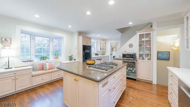 a kitchen with stainless steel appliances granite countertop a stove and a sink