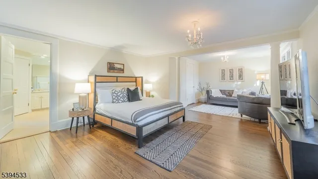 a bedroom with a bed a large window and couch