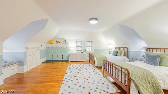 a bedroom with three beds and a baby crib