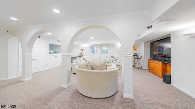 a view of a living room and kitchen with a sink