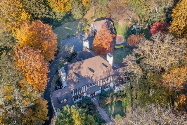 an aerial view of a house with a yard and swimming pool