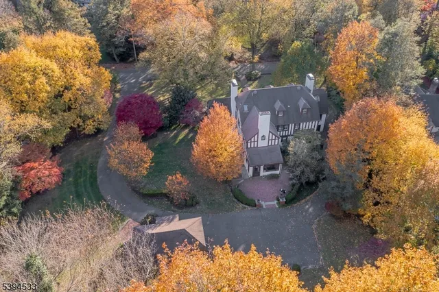 a backyard of a house with a yard and outdoor seating
