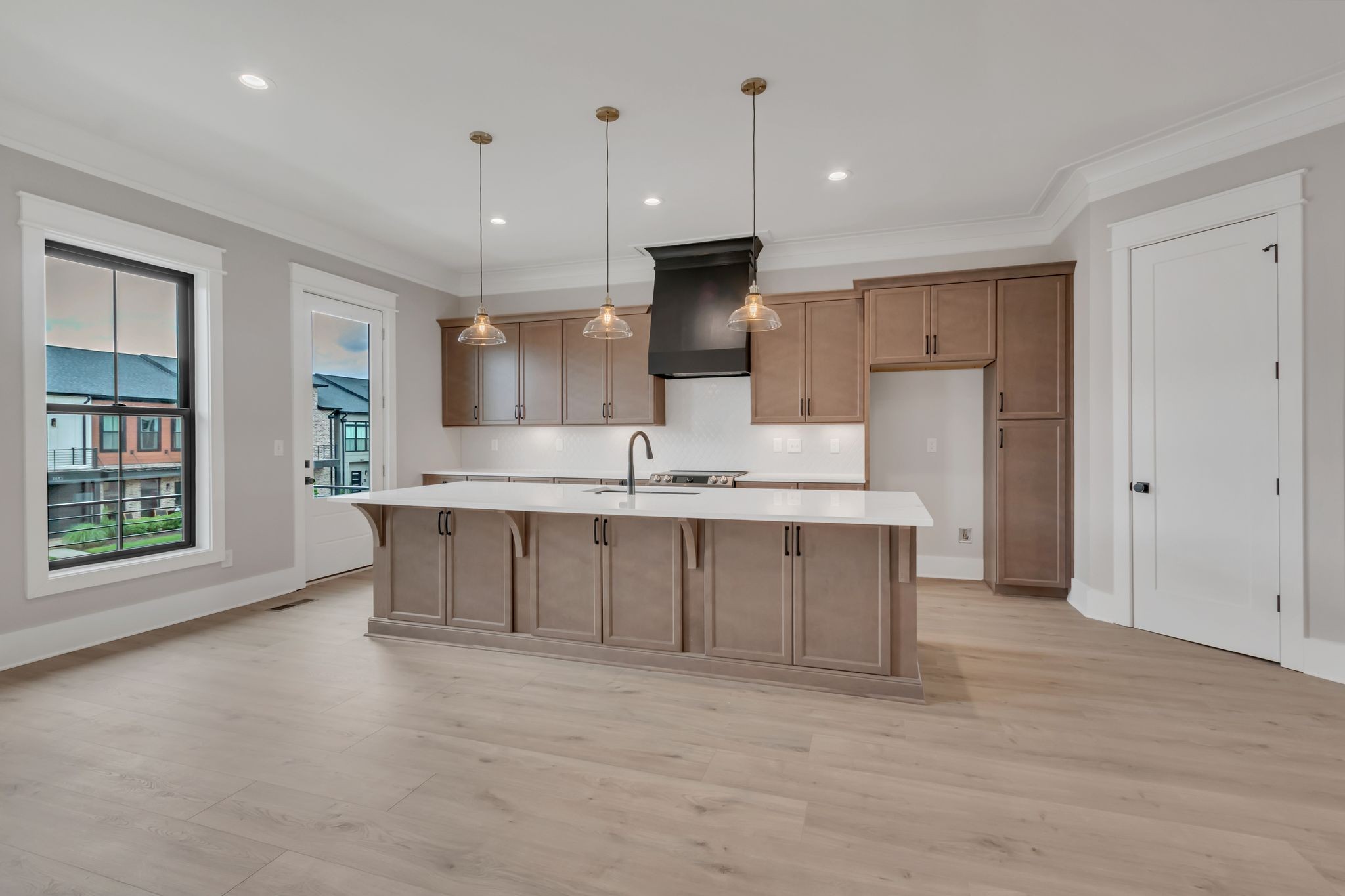 1445 Doc Johns Boulevard Murfreesboro, TN 37128 - Photo 15 of 54 a large kitchen with kitchen island granite countertop a stove a sink a refrigerator and white cabinets with wooden floor