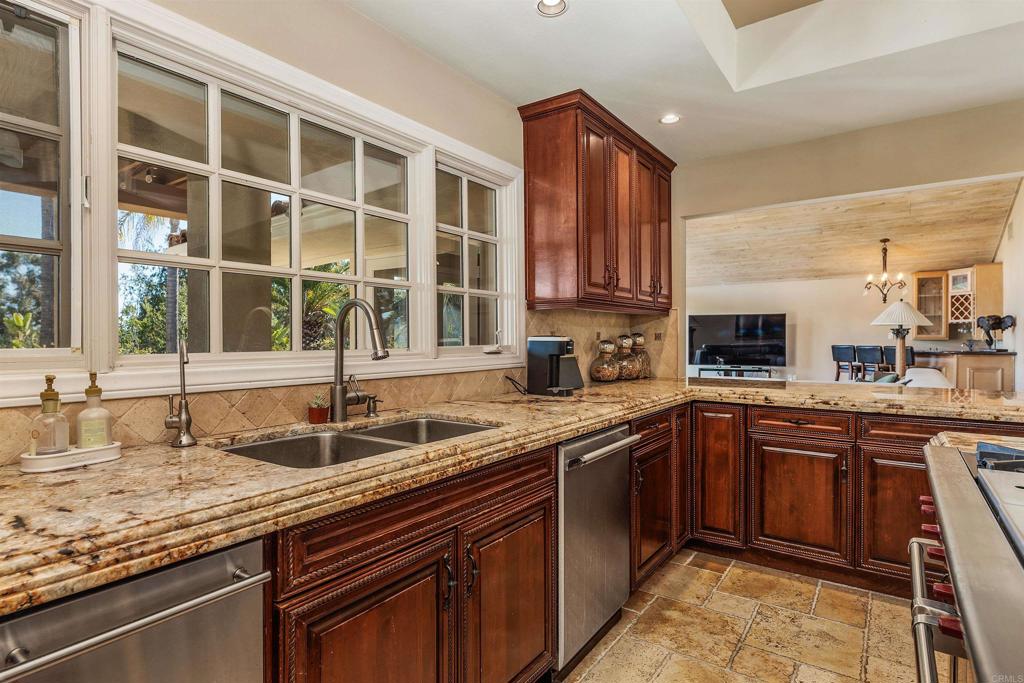 16346 Via Del Alba Rancho Santa Fe, CA 92067 - Photo 9 of 34 a kitchen with a sink stove and cabinets