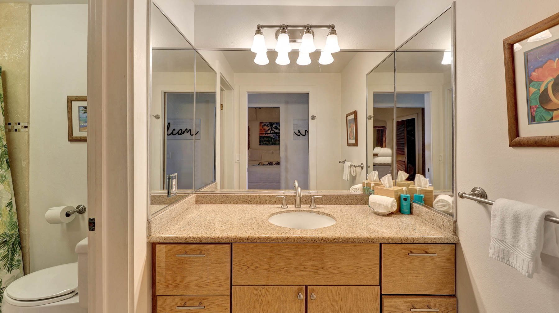 2253 Poipu Road, Unit 218 Koloa, HI 96756 - Photo 20 of 23 a bathroom with a granite countertop sink a toilet and a mirror