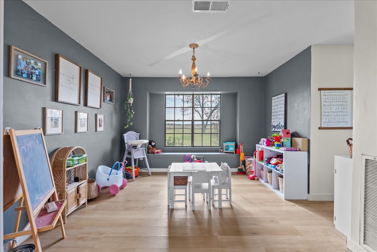 10803 Oberrender Road Needville, TX 77461 - Photo 11 of 36 a living room filled with furniture and a chandelier