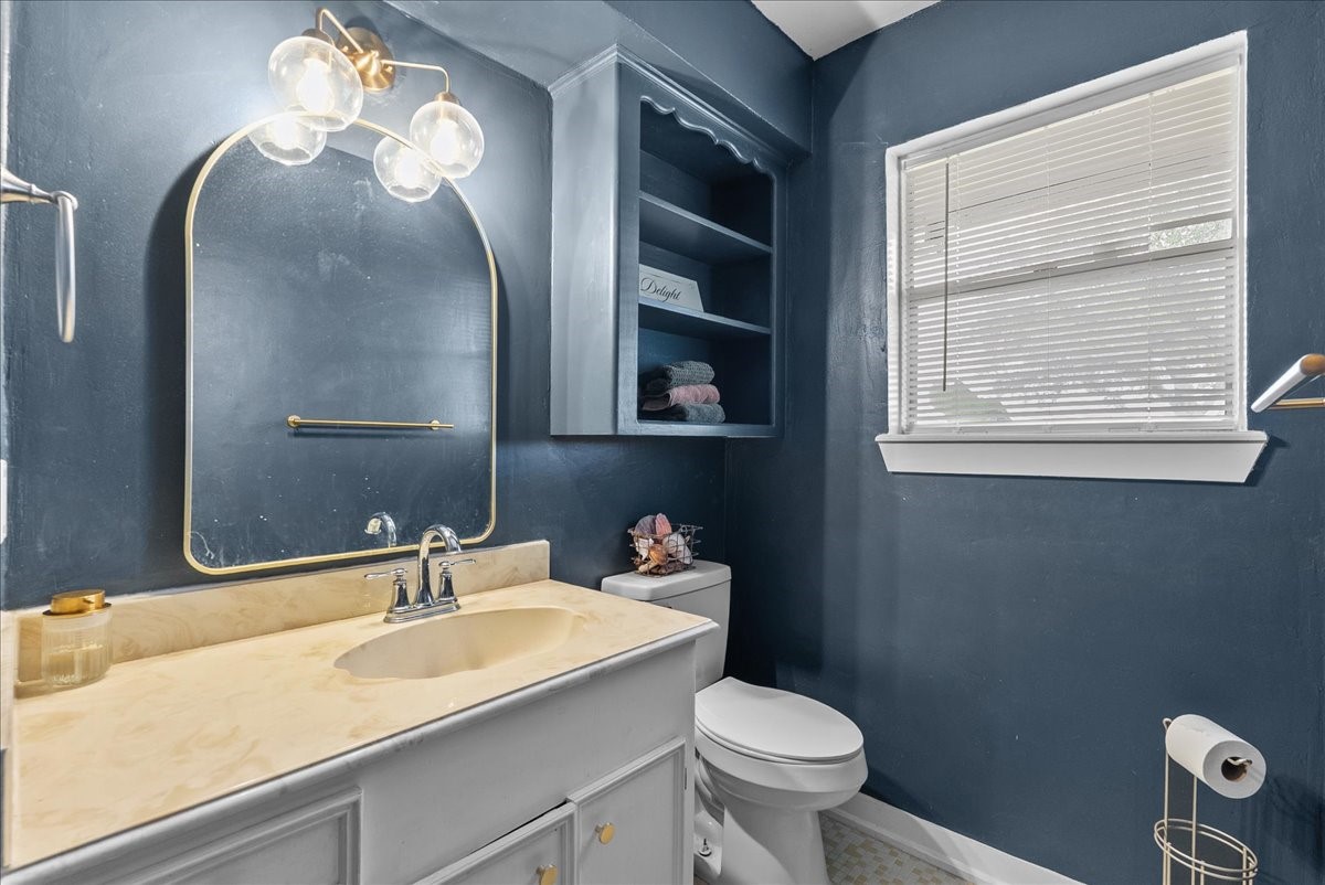 10803 Oberrender Road Needville, TX 77461 - Photo 14 of 36 a bathroom with a sink a toilet and a mirror