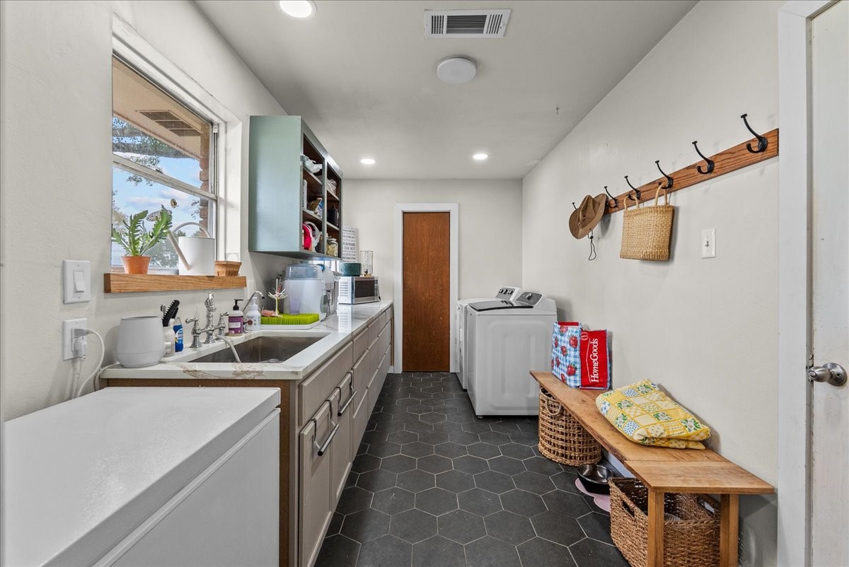 10803 Oberrender Road Needville, TX 77461 - Photo 15 of 36 a kitchen that has a lot of cabinets a sink and a stove in it