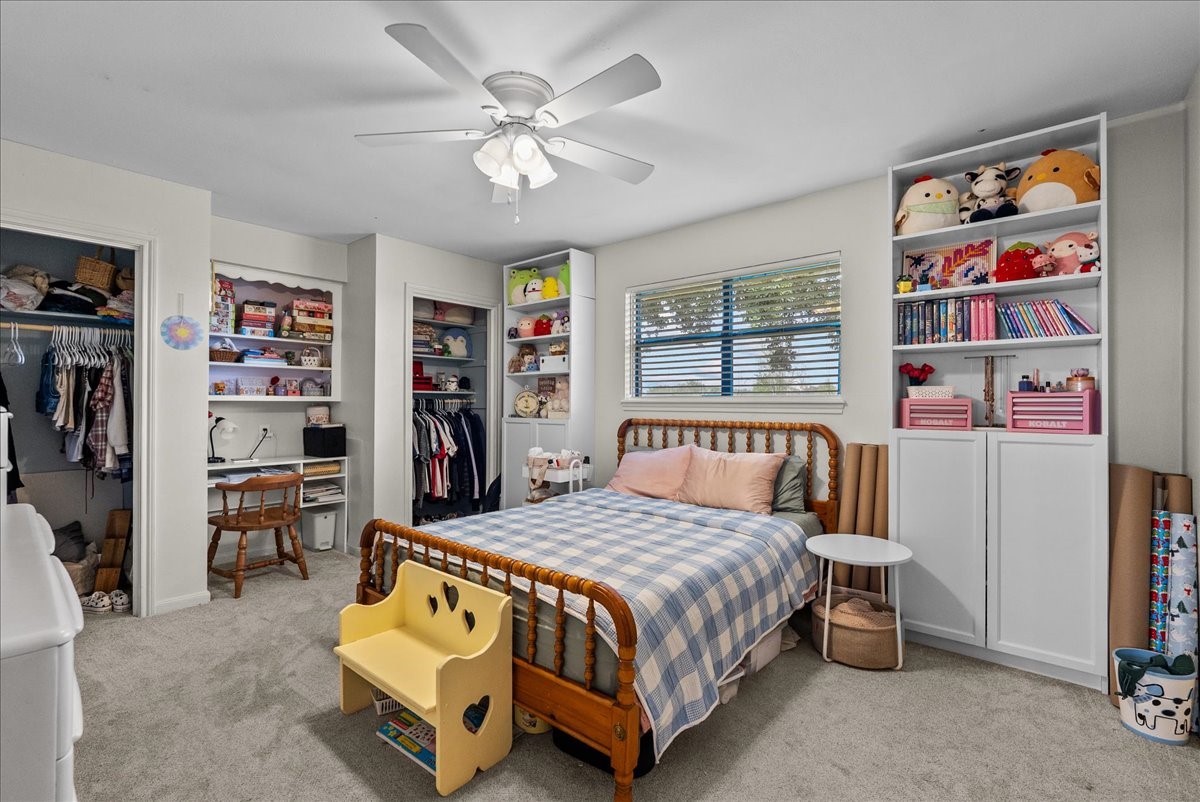 10803 Oberrender Road Needville, TX 77461 - Photo 24 of 36 a bedroom with a bed and a book shelf