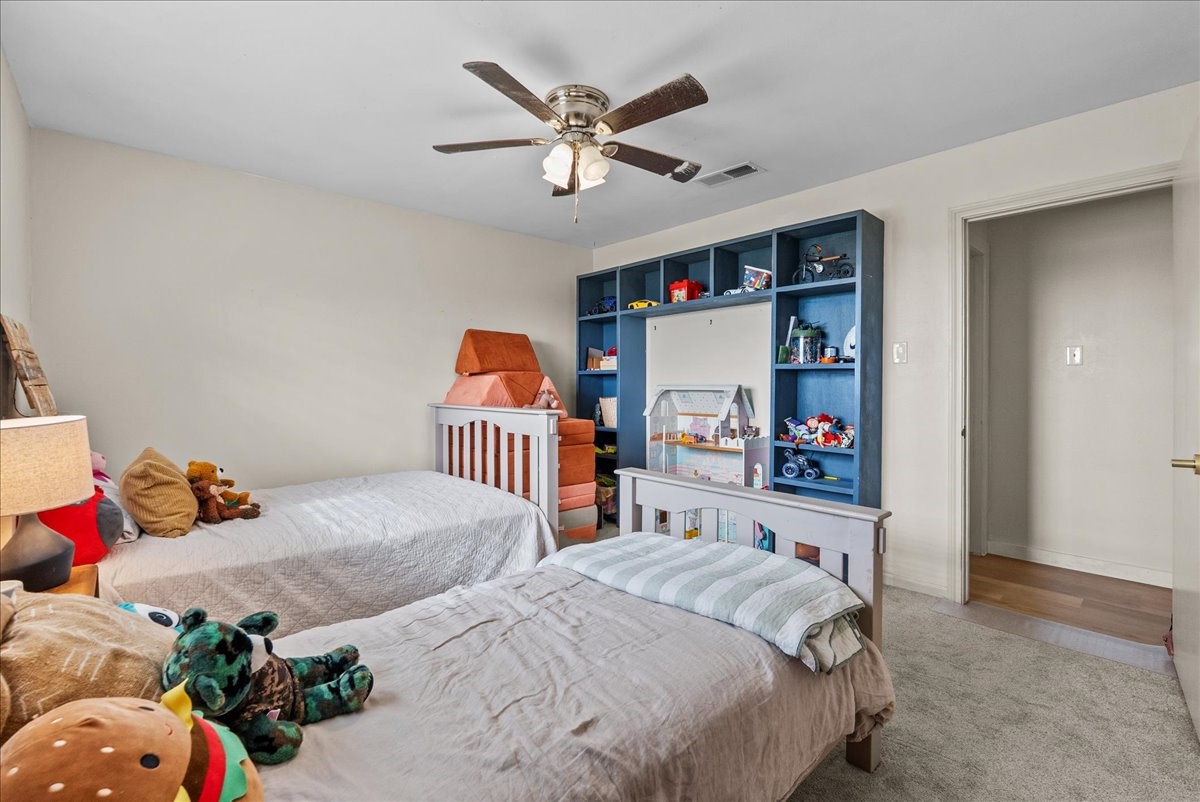 10803 Oberrender Road Needville, TX 77461 - Photo 25 of 36 a bedroom with two beds and a window