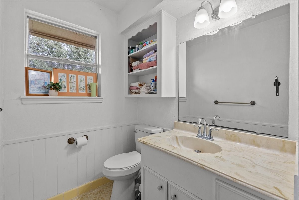 10803 Oberrender Road Needville, TX 77461 - Photo 29 of 36 a bathroom with a granite countertop sink mirror and toilet