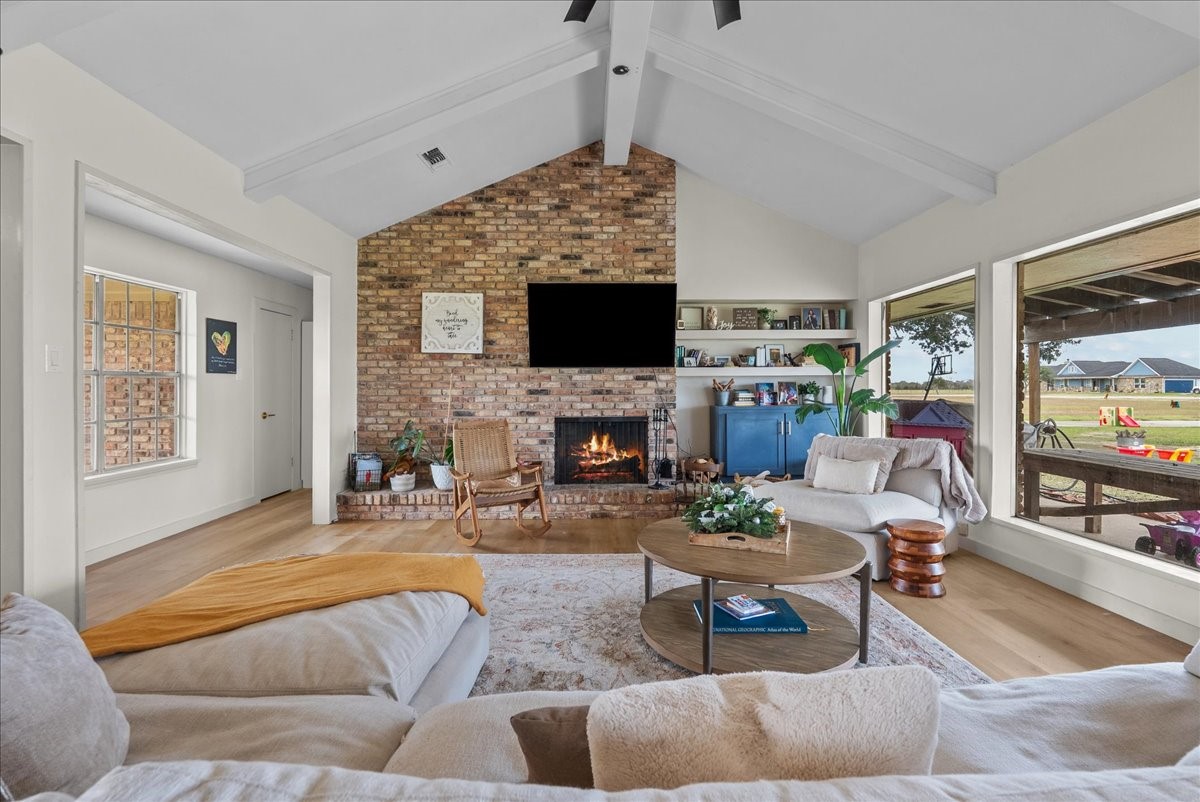 10803 Oberrender Road Needville, TX 77461 - Photo 7 of 36 a living room with furniture a fireplace and a flat screen tv