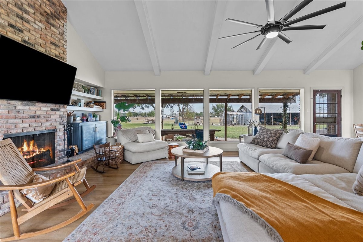 10803 Oberrender Road Needville, TX 77461 - Photo 10 of 36 a living room with furniture a flat screen tv and a fireplace