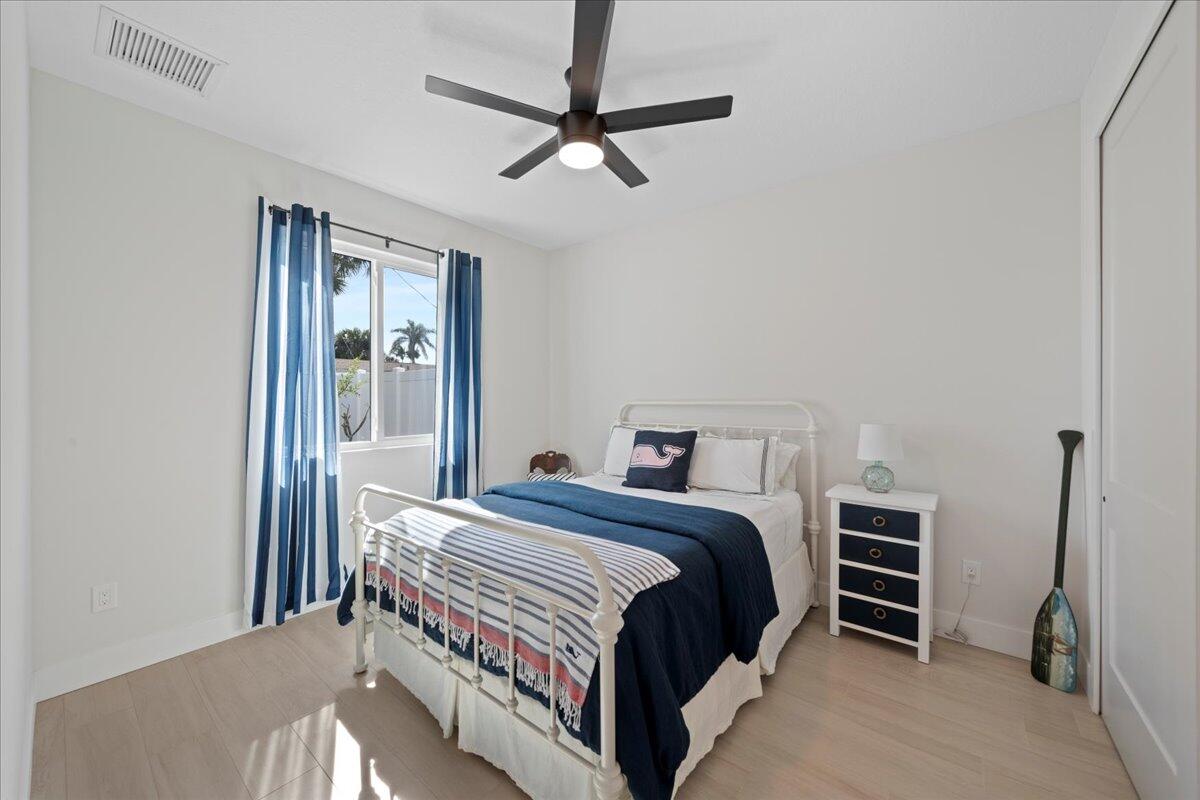 223 6th Avenue Indialantic, FL 32903 - Photo 11 of 26 a bedroom with a bed and a ceiling fan