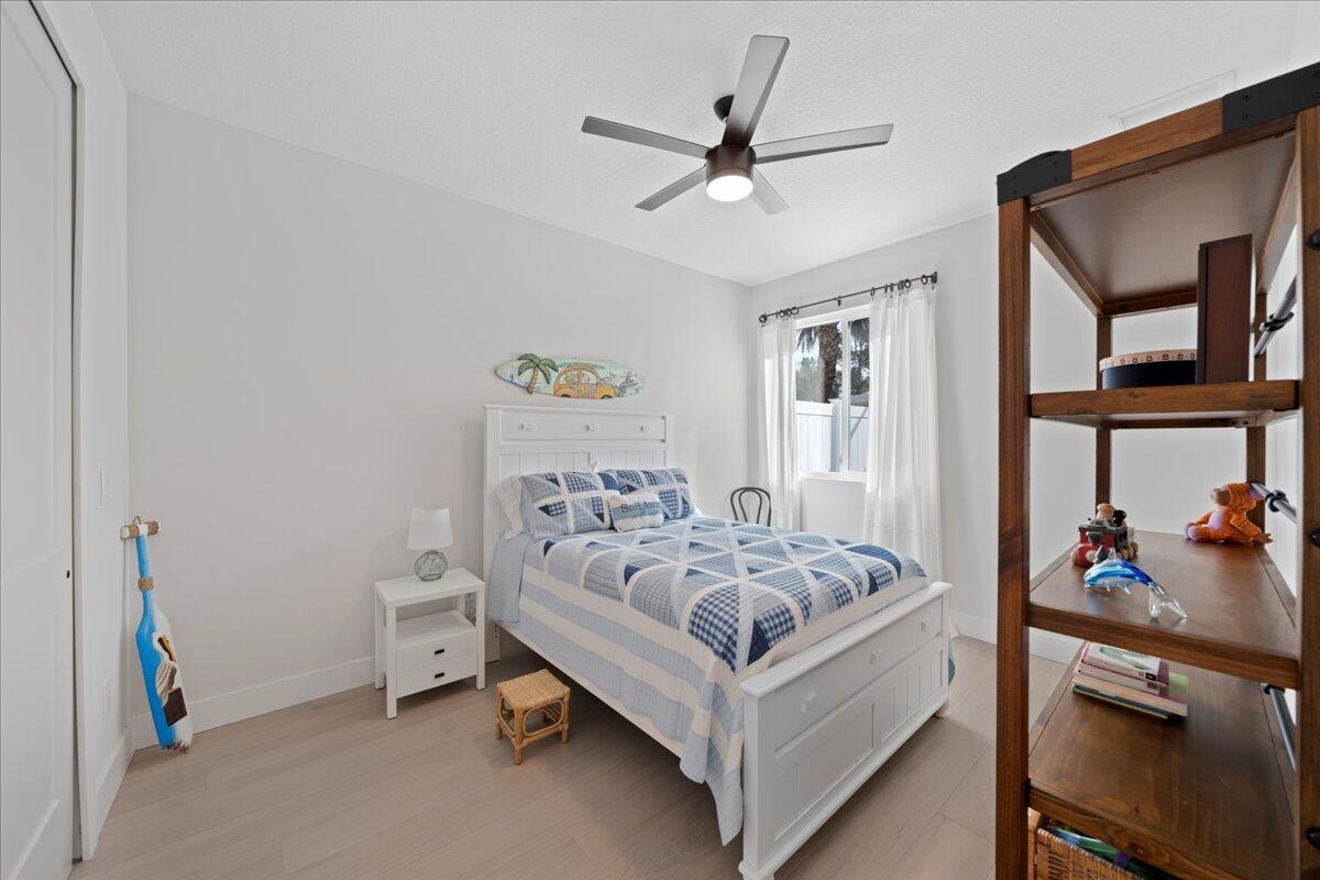 223 6th Avenue Indialantic, FL 32903 - Photo 13 of 26 a white bed sitting in a bedroom next to a window