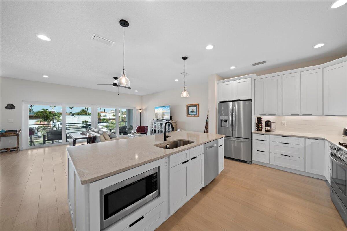 223 6th Avenue Indialantic, FL 32903 - Photo 4 of 26 a kitchen with a sink stove and cabinets