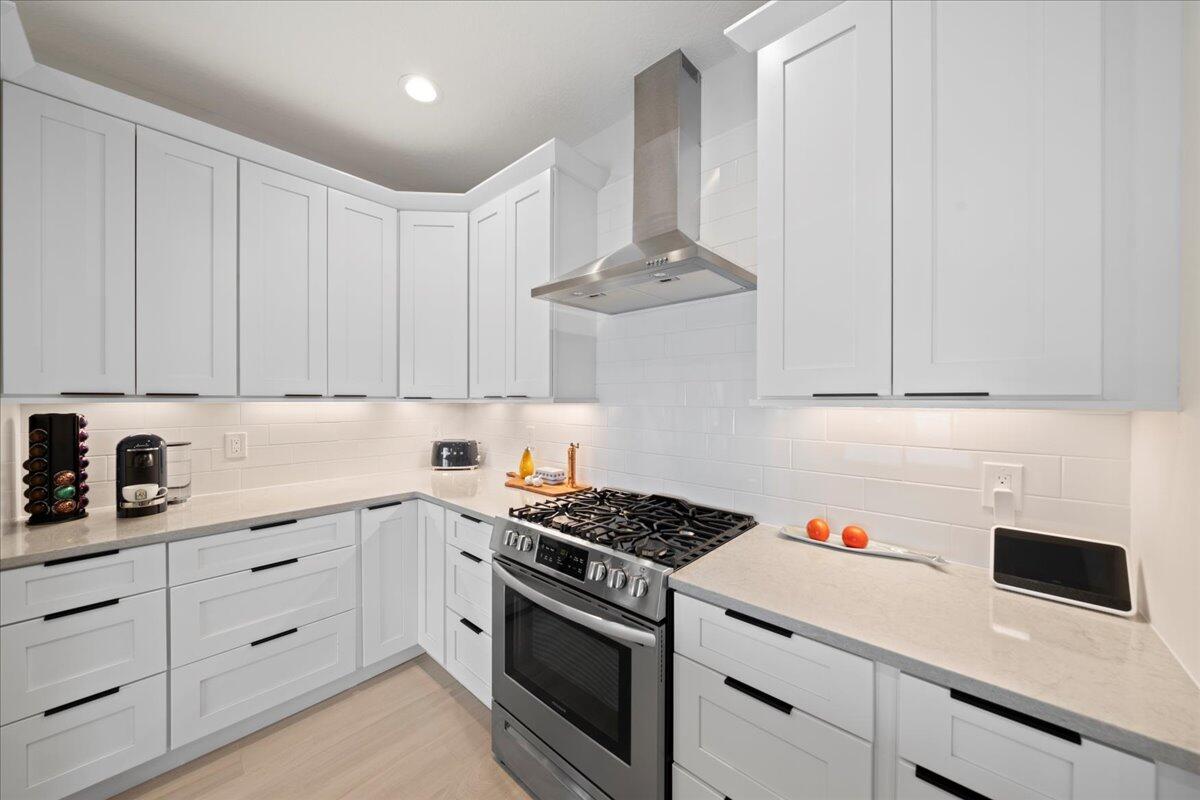 223 6th Avenue Indialantic, FL 32903 - Photo 6 of 26 a kitchen with white cabinets and appliances