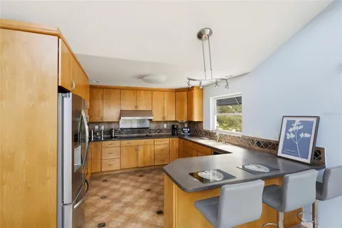 a spacious bathroom with a granite countertop sink mirror and a bathtub