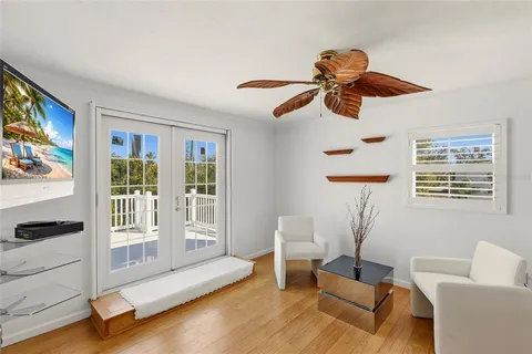 a view of a roof deck with table and chairs with wooden floor and fence