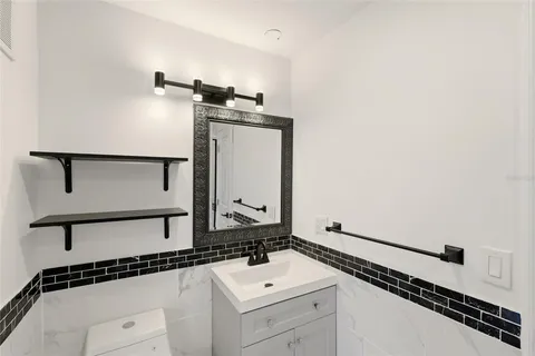 a living room with furniture fireplace and a large window