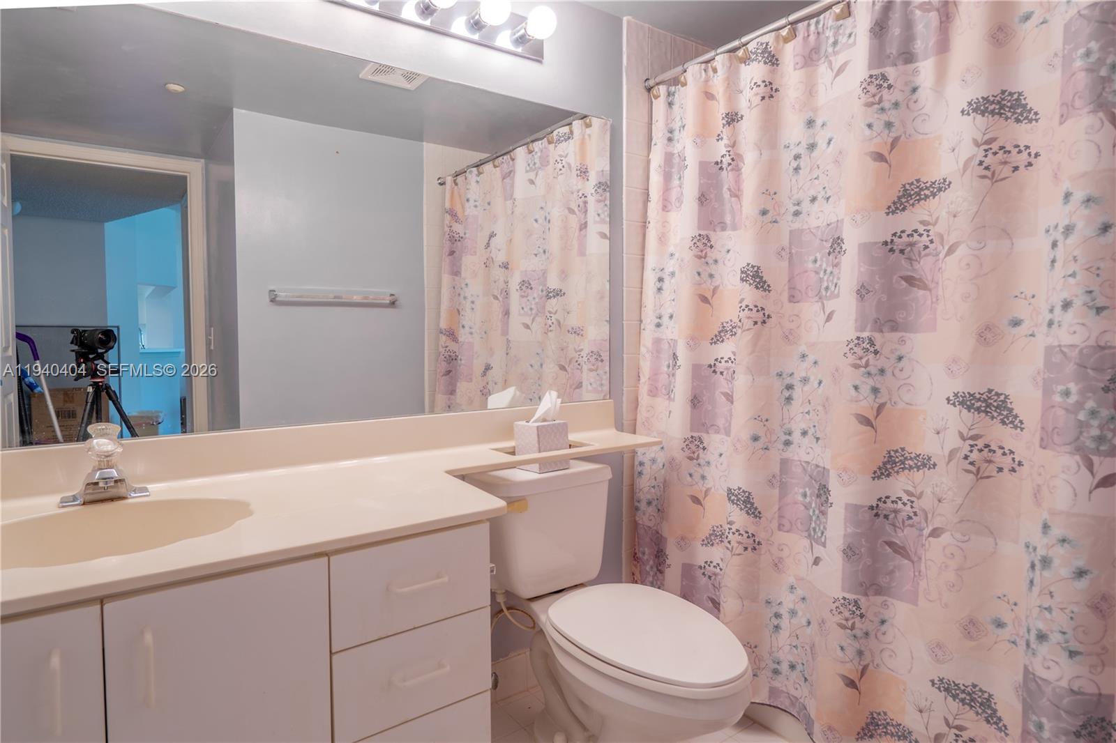 2541 North Nob Hill Road, Unit 309 Sunrise, FL 33322 - Photo 11 of 31 a bathroom with a granite countertop toilet sink and mirror